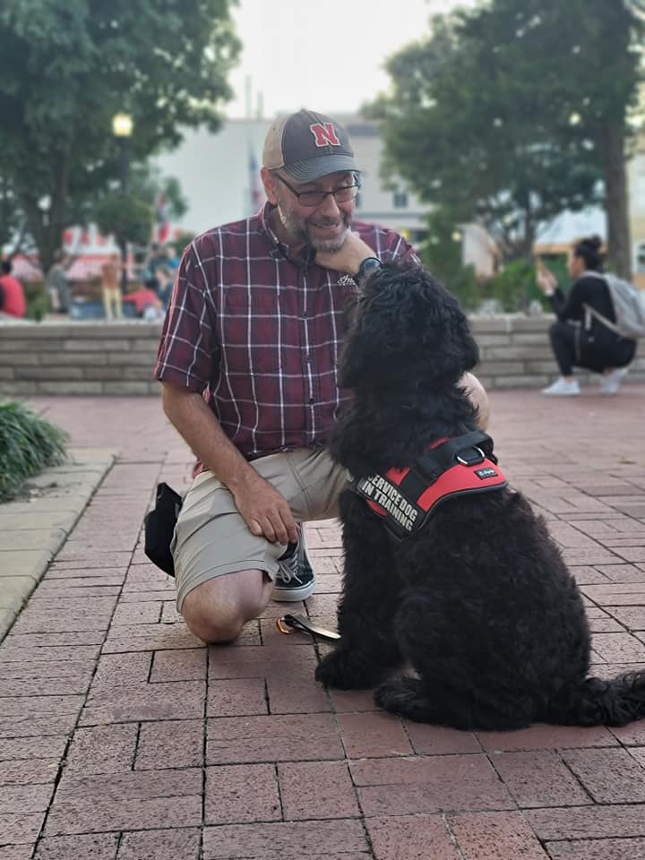 Male dog trainer with service dog. Picture links to the Personalized Training page.